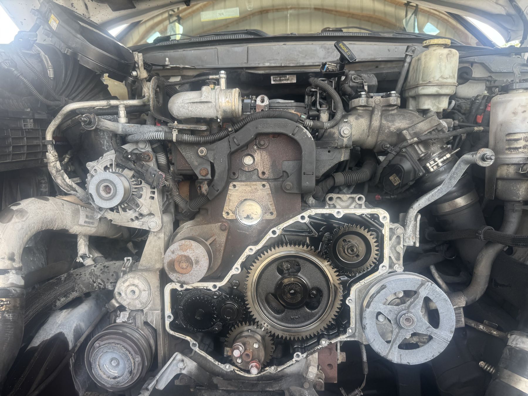 Diesel truck engine with the front timing cover removed during an on-site repair
